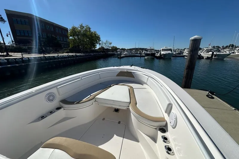 Slide: The Image of 2015 Edgewater 320CC boat docked at marina under clear blue sky. - 22