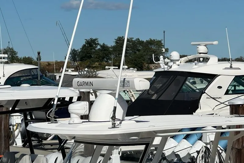 Slide: The Image of Boats docked at marina, featuring 2015 Edgewater 320CC with Garmin equipment. - 25