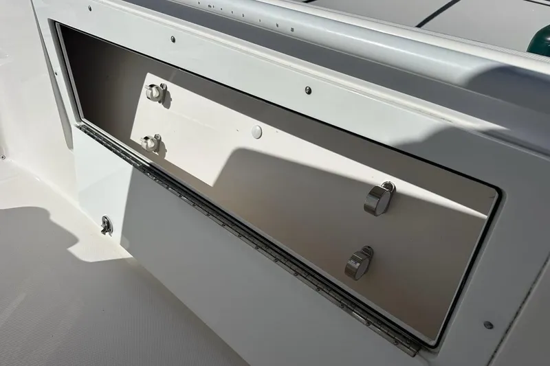 Slide: The Image of Storage compartment on a 2015 Edgewater 320CC boat, featuring secure latches. - 26