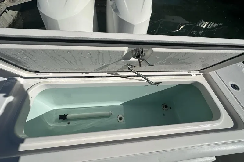 Slide: The Image of Open storage compartment on 2015 Edgewater 320CC boat, showing interior details. - 28
