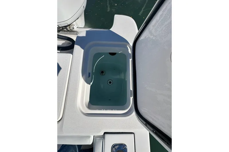 Slide: The Image of Open storage compartment on 2015 Edgewater 320CC boat, showing interior details. - 29