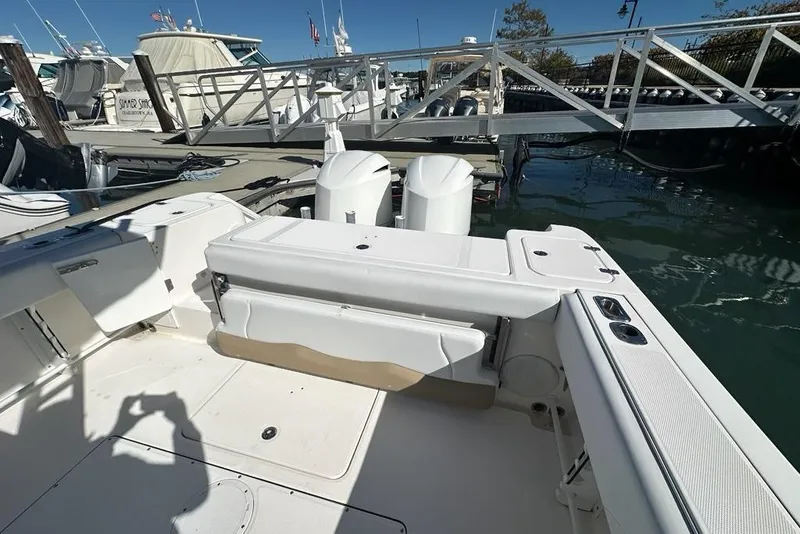 Slide: The Image of 2015 Edgewater 320CC boat docked at marina with dual outboard engines. - 30