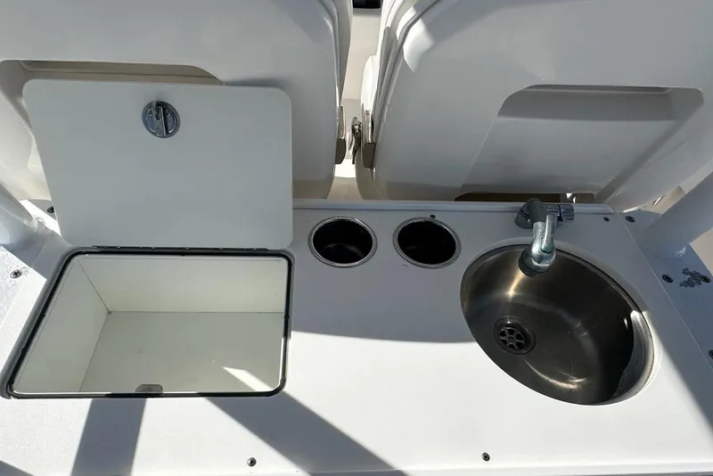 Slide: The Image of Edgewater 320CC 2015 boat interior with sink and storage compartment. - 7