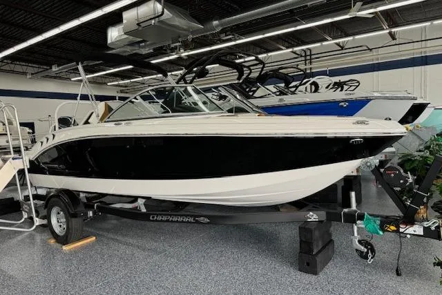Slide: The Image of 2024 Chaparral 19 SSi OB boat displayed indoors on a trailer. - 1