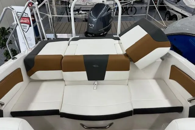 Slide: The Image of 2024 Chaparral 19 SSi OB boat interior with stylish seating and outboard motor. - 10