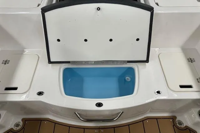Slide: The Image of 2024 Chaparral 19 SSi OB boat interior with open storage compartment. - 14