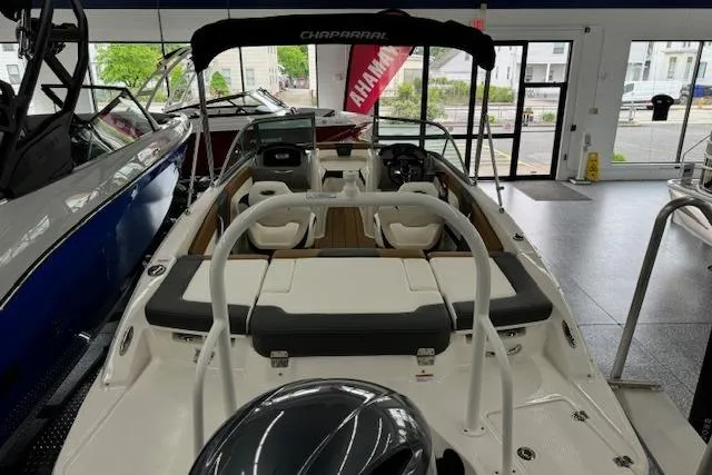 Slide: The Image of 2024 Chaparral 19 SSi OB boat interior with seating and controls in showroom. - 15