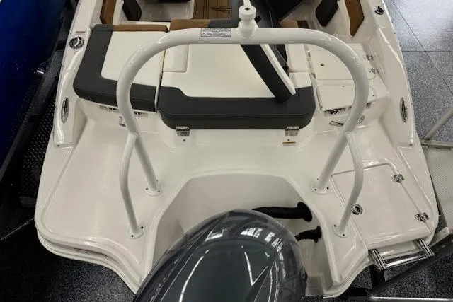 Slide: The Image of 2024 Chaparral 19 SSi OB boat, rear view with seating and outboard motor. - 17
