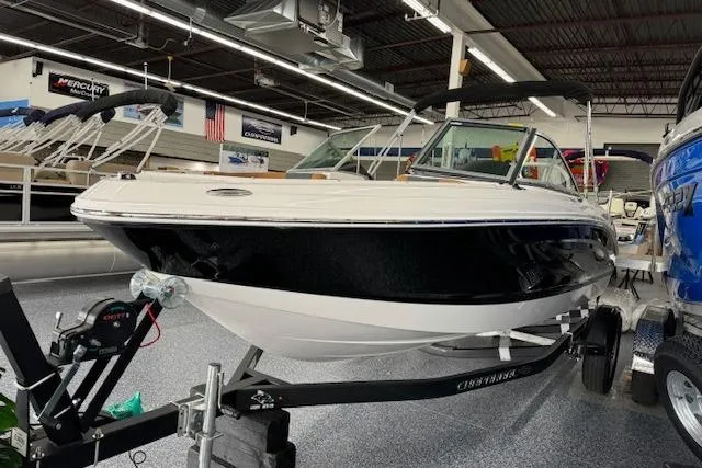 Slide: The Image of 2024 Chaparral 19 SSi OB boat displayed indoors on a trailer. - 2