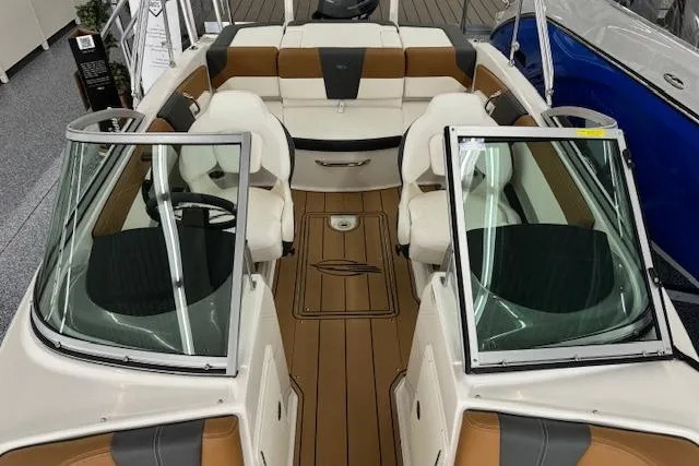 Slide: The Image of 2024 Chaparral 19 SSi OB boat interior with tan and white seating, open windshield. - 4