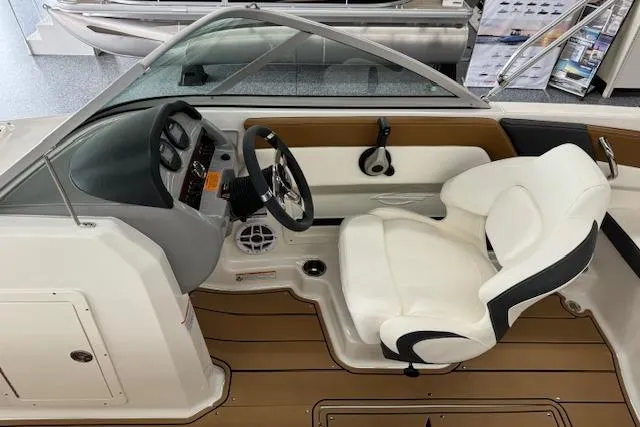 Slide: The Image of 2024 Chaparral 19 SSi OB boat interior with steering wheel and seating. - 6