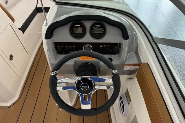 Slide: The Image of 2024 Chaparral 19 SSi OB boat dashboard with steering wheel and gauges. - 7
