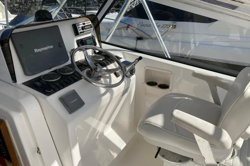 Slide: The Image of Helm of 2006 Luhrs 28 boat with Raymarine electronics and comfortable seating. - 11