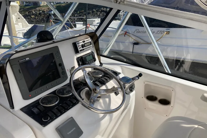 Slide: The Image of 2006 Luhrs 28 boat helm with navigation equipment and steering wheel. - 12
