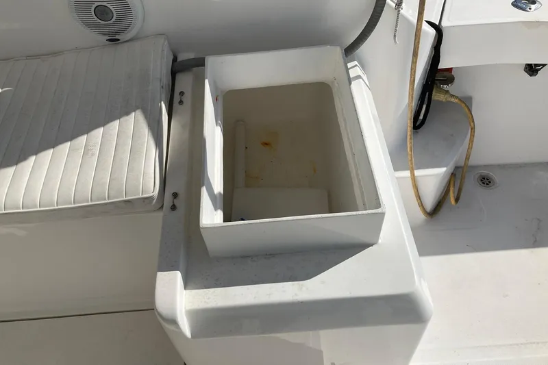 Slide: The Image of 2006 Luhrs 28 boat interior with storage compartment and cushioned seating. - 20