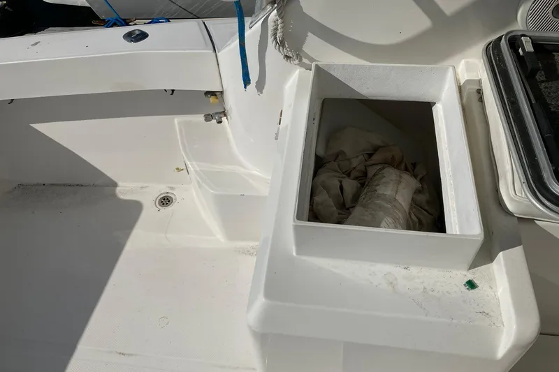 Slide: The Image of 2006 Luhrs 28 boat deck with storage compartment and drain. - 21