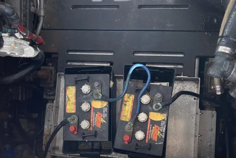 Slide: The Image of Battery compartment of a 2006 Luhrs 28 boat with connected cables. - 25