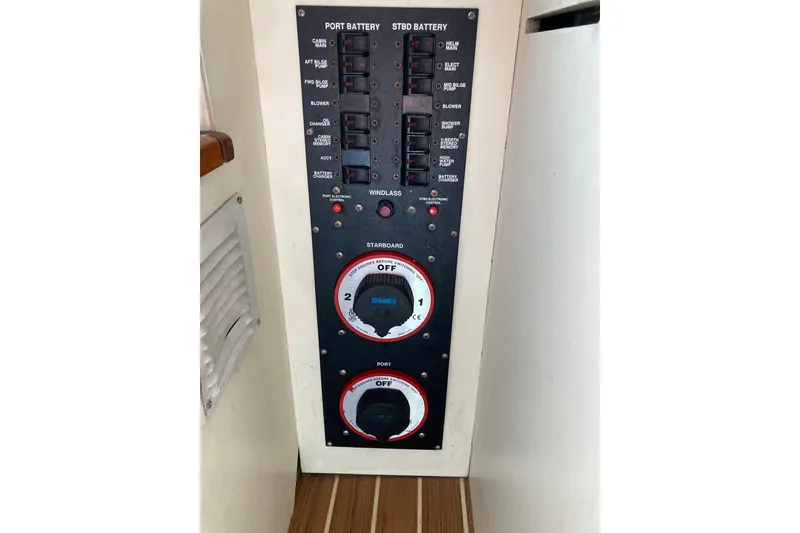 Slide: The Image of Electrical panel of a 2006 Luhrs 28 boat, featuring battery switches and circuit breakers. - 26