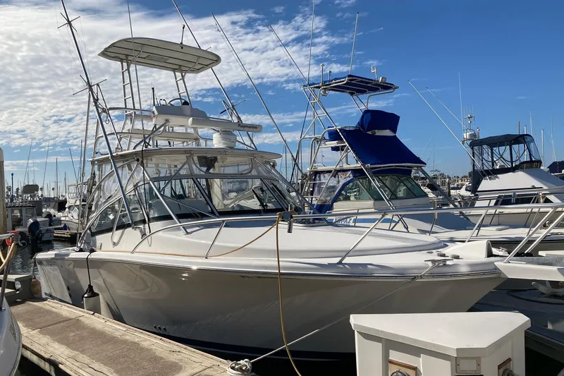 Slide: The Image of 2006 Luhrs 28 boat docked at marina under clear blue sky. - 3