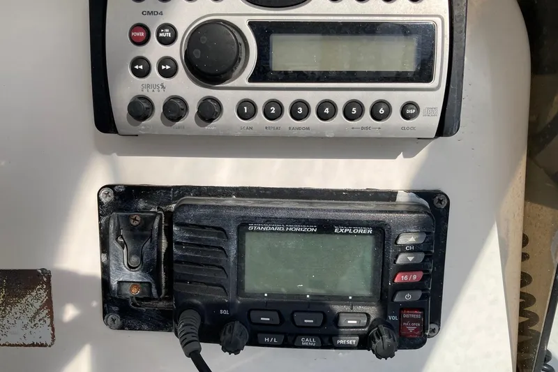 Slide: The Image of Control panel of a 2006 Luhrs 28 boat featuring radio and navigation equipment. - 30