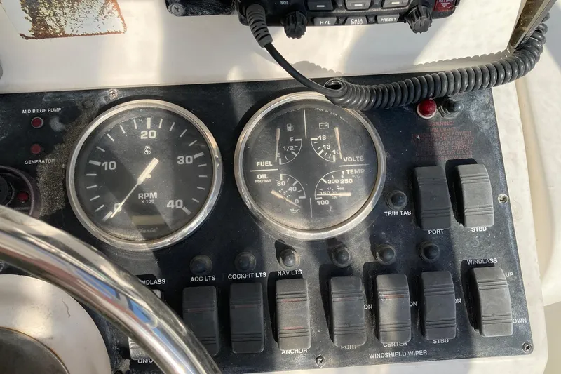 Slide: The Image of Control panel of a 2006 Luhrs 28 boat with gauges and switches. - 31