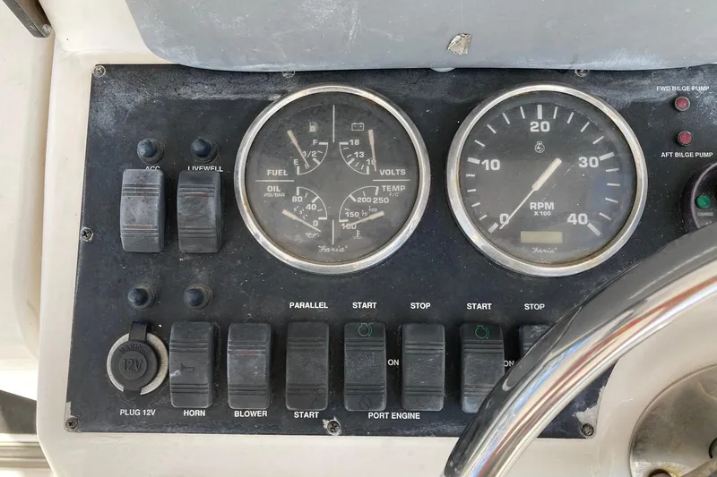 Slide: The Image of Control panel of a 2006 Luhrs 28 boat with gauges and switches. - 32