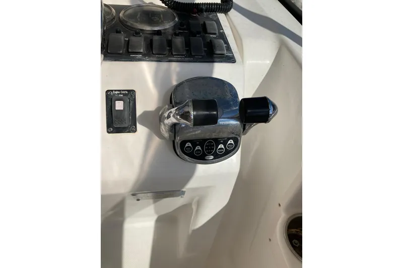 Slide: The Image of Control panel of a 2006 Luhrs 28 boat with throttle and switches. - 33
