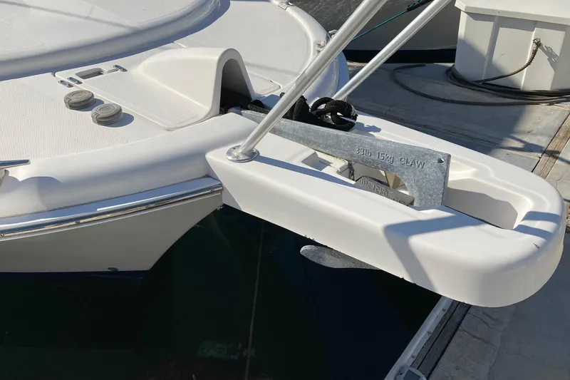 Slide: The Image of 2006 Luhrs 28 boat anchor detail with claw anchor on deck. - 5