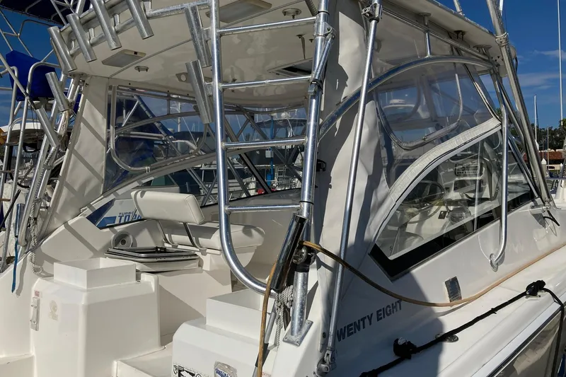 Slide: The Image of 2006 Luhrs 28 boat with sleek design and modern features, docked at marina. - 7