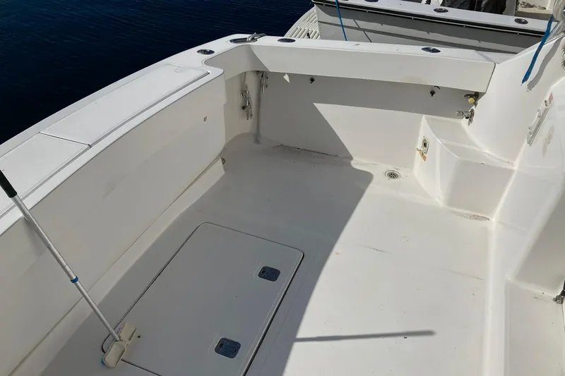 Slide: The Image of 2006 Luhrs 28 boat deck with clean white surface and storage compartments. - 8