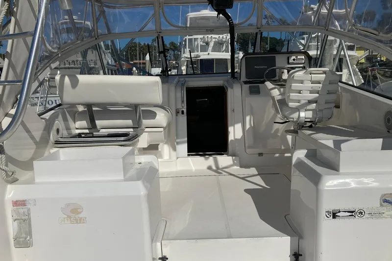 Slide: The Image of 2006 Luhrs 28 boat interior with white seating and steering area. - 9