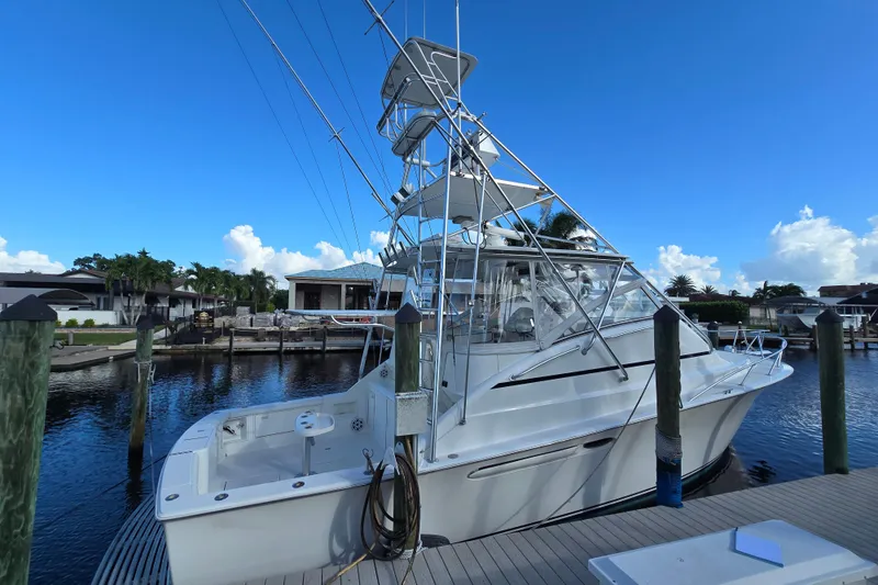 Slide: The Image of 1999 Ocean Yachts 40 Open docked, featuring a sleek design and spacious deck. - 12