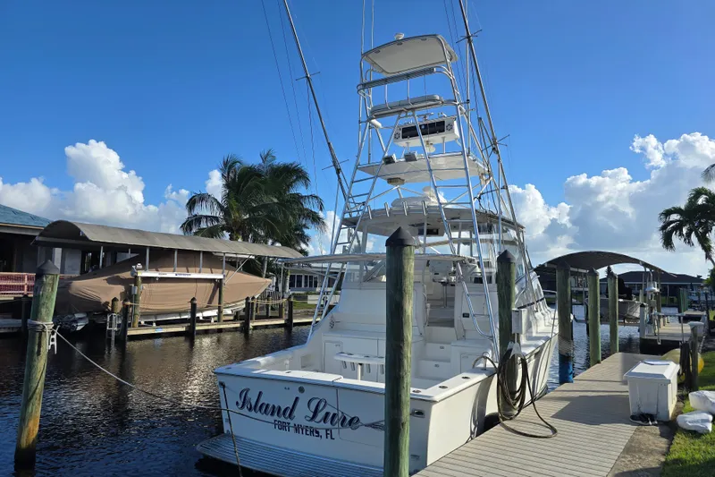 Slide: The Image of 1999 Ocean Yachts 40 Open docked in Fort Myers, Florida, under a clear blue sky. - 13
