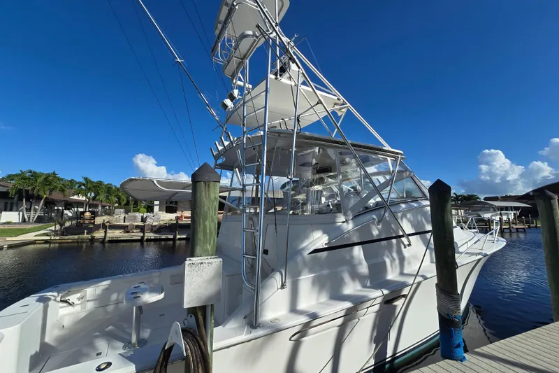 Slide: The Image of 1999 Ocean Yachts 40 Open docked under clear blue sky. - 15