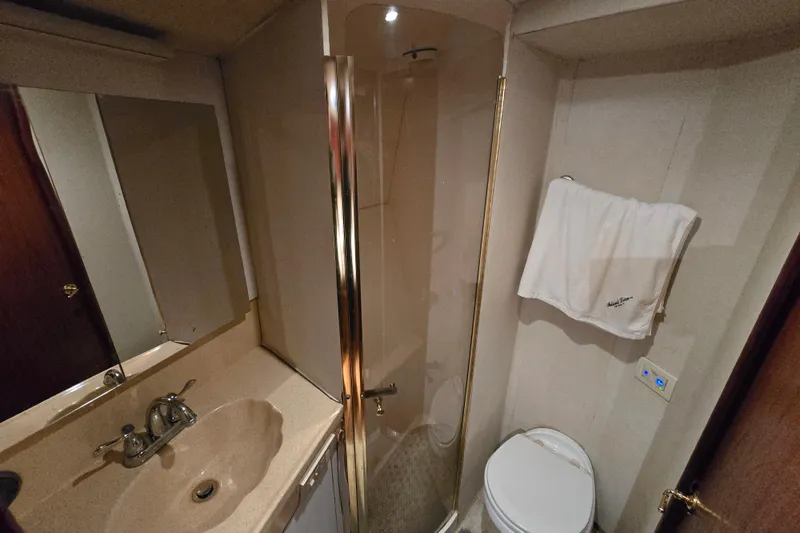Slide: The Image of Bathroom interior of 1999 Ocean Yachts 40 Open, featuring shower, sink, and toilet. - 29