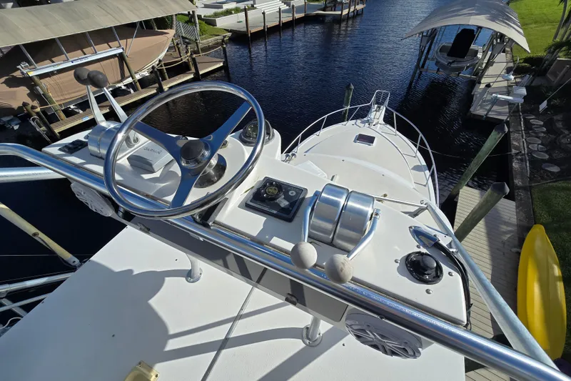 Slide: The Image of 1999 Ocean Yachts 40 Open helm view, docked in a marina. - 35