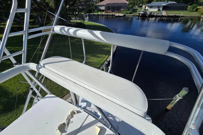 Slide: The Image of 1999 Ocean Yachts 40 Open boat deck with seating, overlooking a serene waterfront. - 36