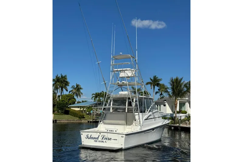 Slide: The Image of 1999 Ocean Yachts 40 Open boat docked, clear sky, palm trees in background. - 8
