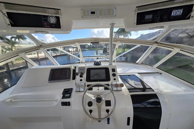 Slide: The Image of 1999 Ocean Yachts 40 Open helm with modern navigation equipment and waterfront view. - 18