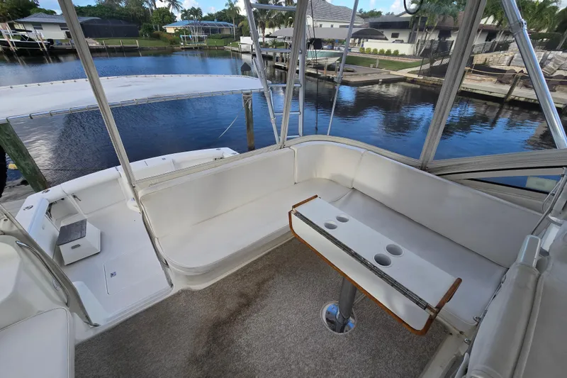 Slide: The Image of 1999 Ocean Yachts 40 Open interior with seating and table, overlooking marina. - 19
