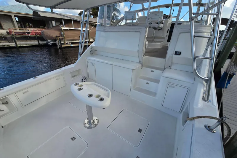 Slide: The Image of 1999 Ocean Yachts 40 Open boat interior with seating and fishing rod holders. - 21
