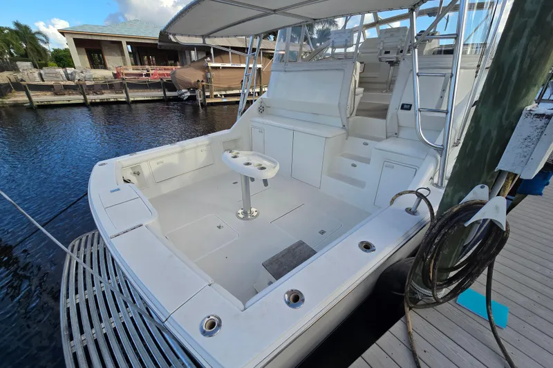 Slide: The Image of 1999 Ocean Yachts 40 Open boat docked, featuring spacious deck and seating area. - 22