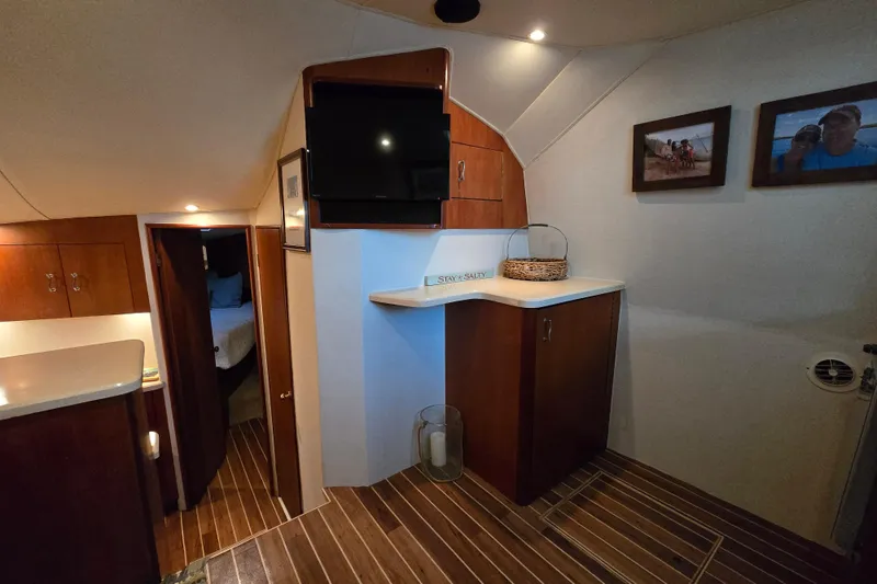 Slide: The Image of Interior of 1999 Ocean Yachts 40 Open, featuring wood cabinetry and cozy living space. - 25