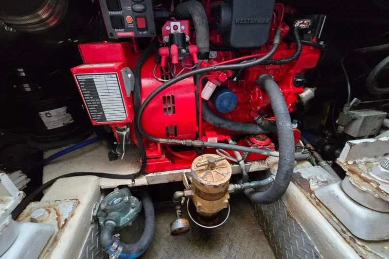 Slide: The Image of Engine compartment of a 1999 Ocean Yachts 40 Open, featuring a red engine and various components. - 39