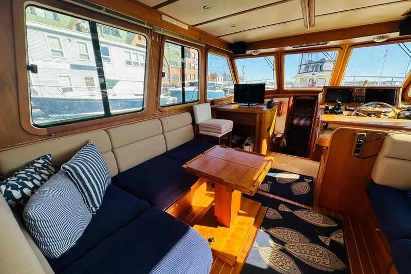 Slide: The Image of Interior of 2006 Sabre 42 Fly Bridge yacht with cozy seating and wooden accents. - 11