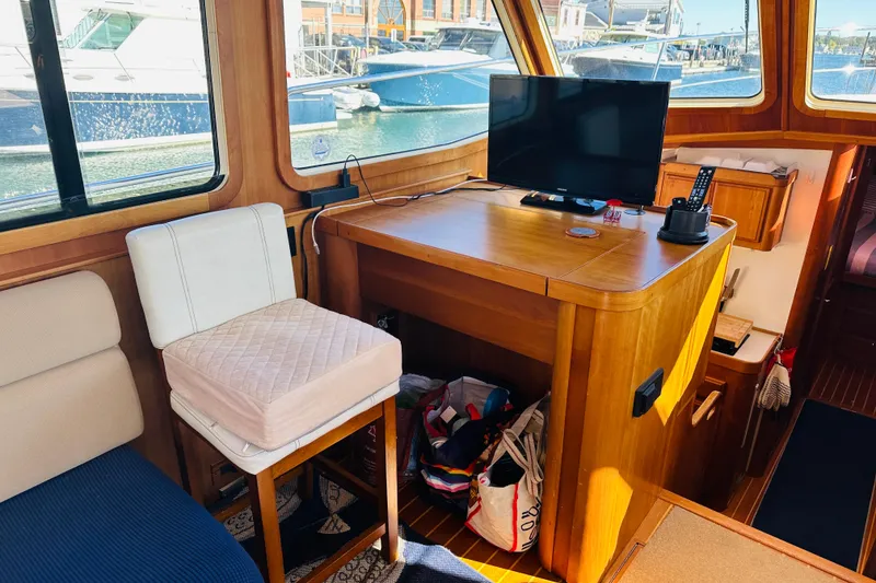 Slide: The Image of Interior of 2006 Sabre 42 Fly Bridge with TV, chair, and wooden cabinetry. - 12