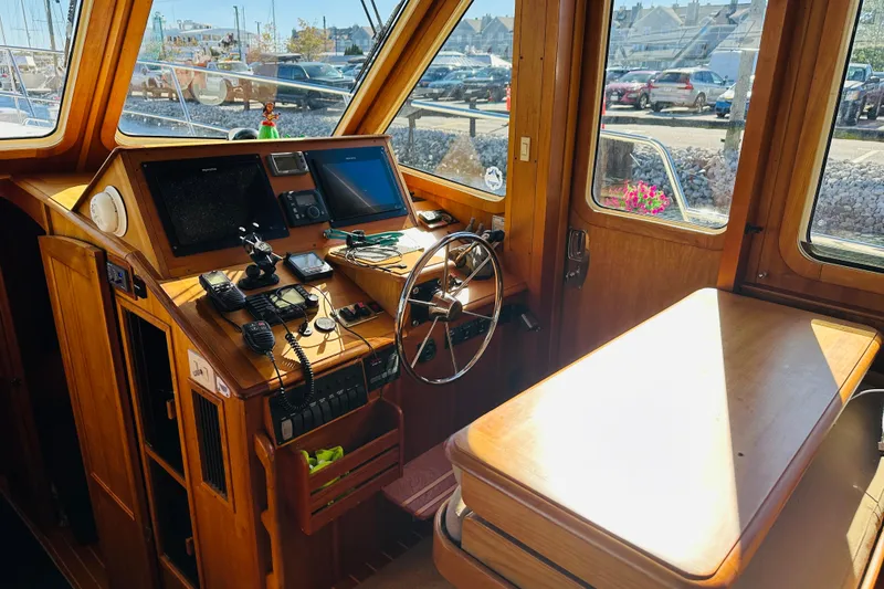 Slide: The Image of 2006 Sabre 42 Fly Bridge helm with wooden interior and navigation equipment. - 13