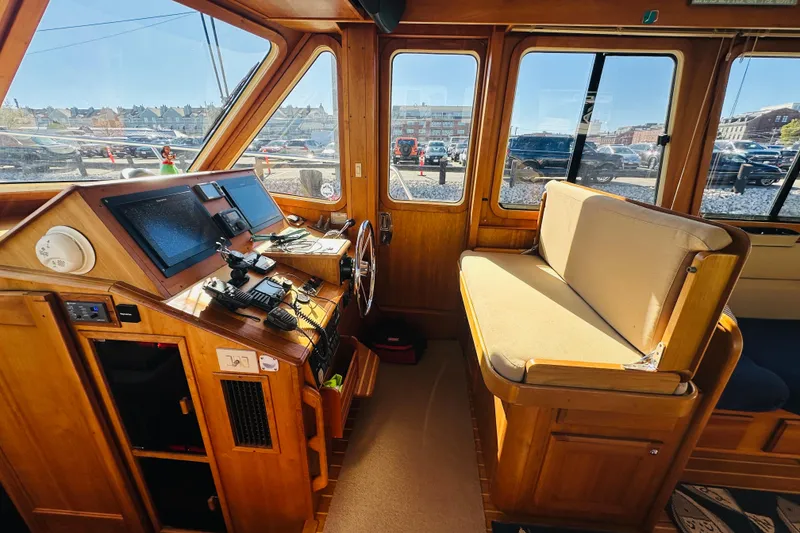 Slide: The Image of 2006 Sabre 42 Fly Bridge interior with navigation controls and seating area. - 14