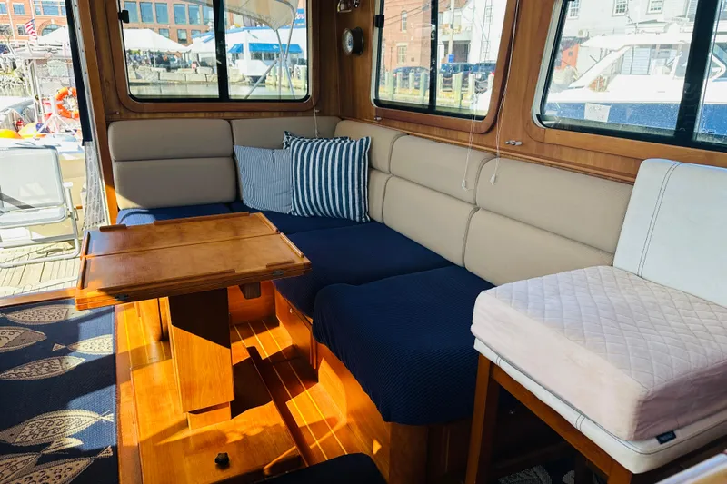 Slide: The Image of Interior of 2006 Sabre 42 Fly Bridge with cozy seating and wooden table. - 16