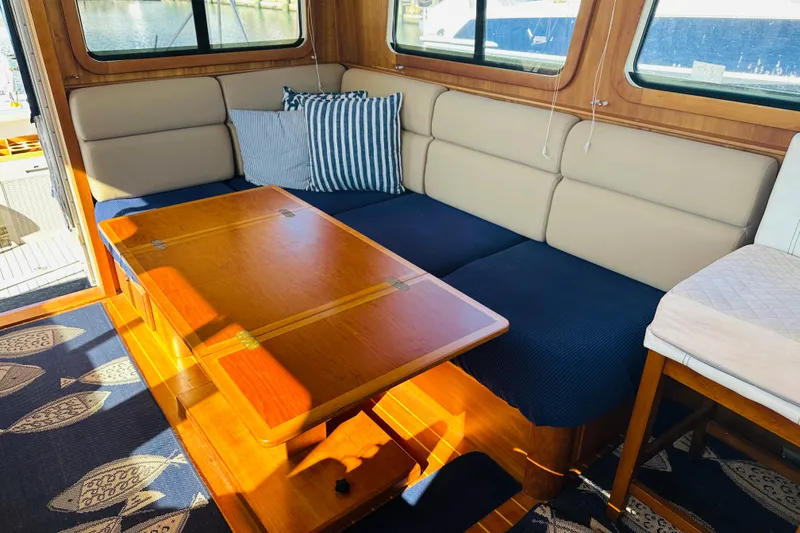 Slide: The Image of Interior of 2006 Sabre 42 Fly Bridge with cozy seating and wooden table. - 18